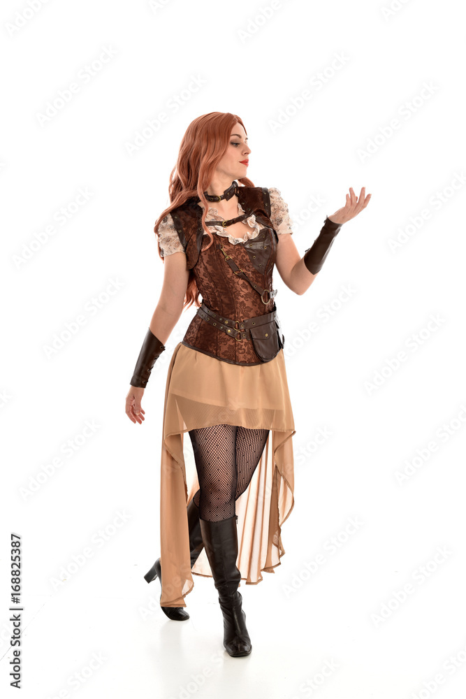 full length portrait of red haired lady wearing steampunk inspired outfit, standing pose against a white background. full length portrait of red haired lady wearing steampunk inspired outfit, standing pose against a white background.