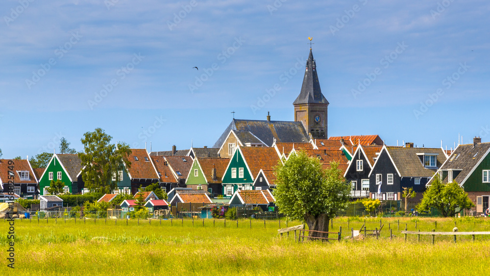 Church towering above Village with colorful wooden houses