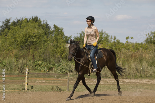 Women is horse riding, vertical