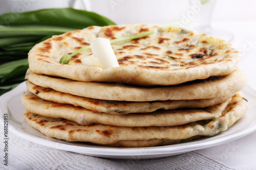 Khychiny – traditional caucasian flatbread filled with сheese and herbs.  Flat bread stuffed with feta and wild garlic.