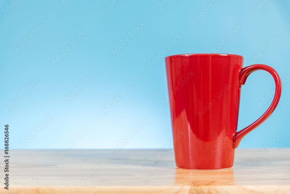 Fototapeta premium red coffee cup on wooden table background