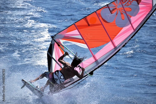 Winderfer moves at high speed on the sea surface against the background of water, waves and splashes Red Sea, Egypt