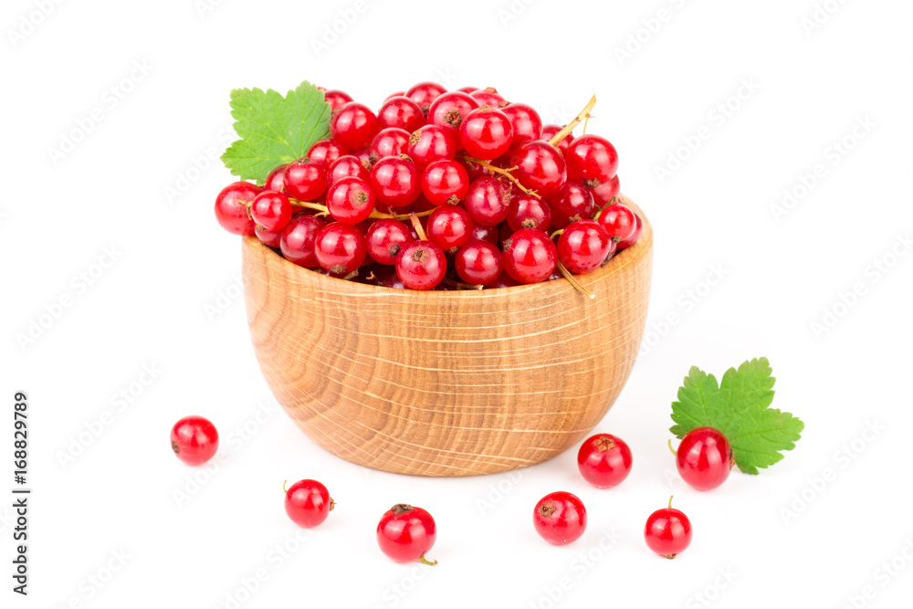 Red currant berries in a wooden bowl with leaf isolated on white background Red currant berries in a wooden bowl with leaf isolated on white background