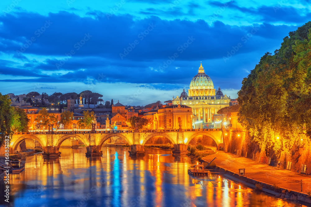 View on Bridge Vittorio Emanuele II (Ponte Vittorio Emanuele II) and Vatican city St. Peter's Basilica (Basilica di San Pietro) at night time. Rome. Italy.