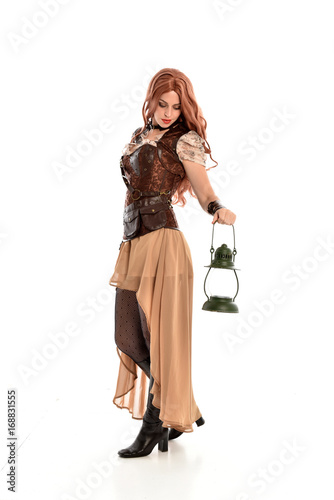 full length portrait of a pretty red haired lady wearing steampunk inspired outfit, standing pose, isolated against white background