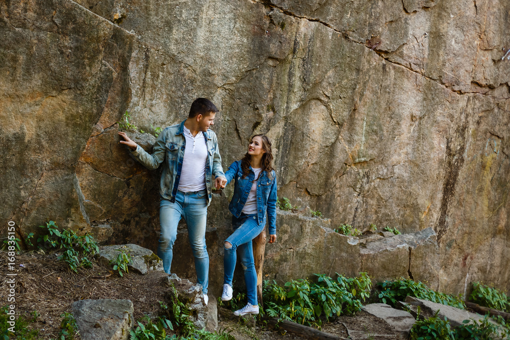 Lovers in jeans walk and laugh at the rocks, canyon