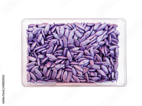 Purple melon seeds in plastic box photo