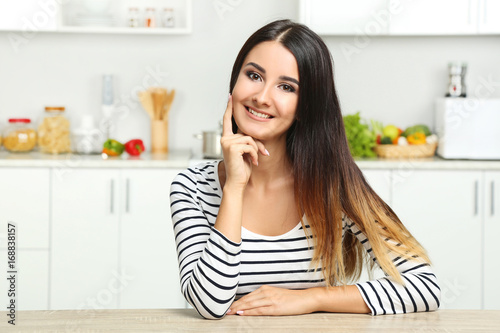 Beautiful young woman in the kitchen