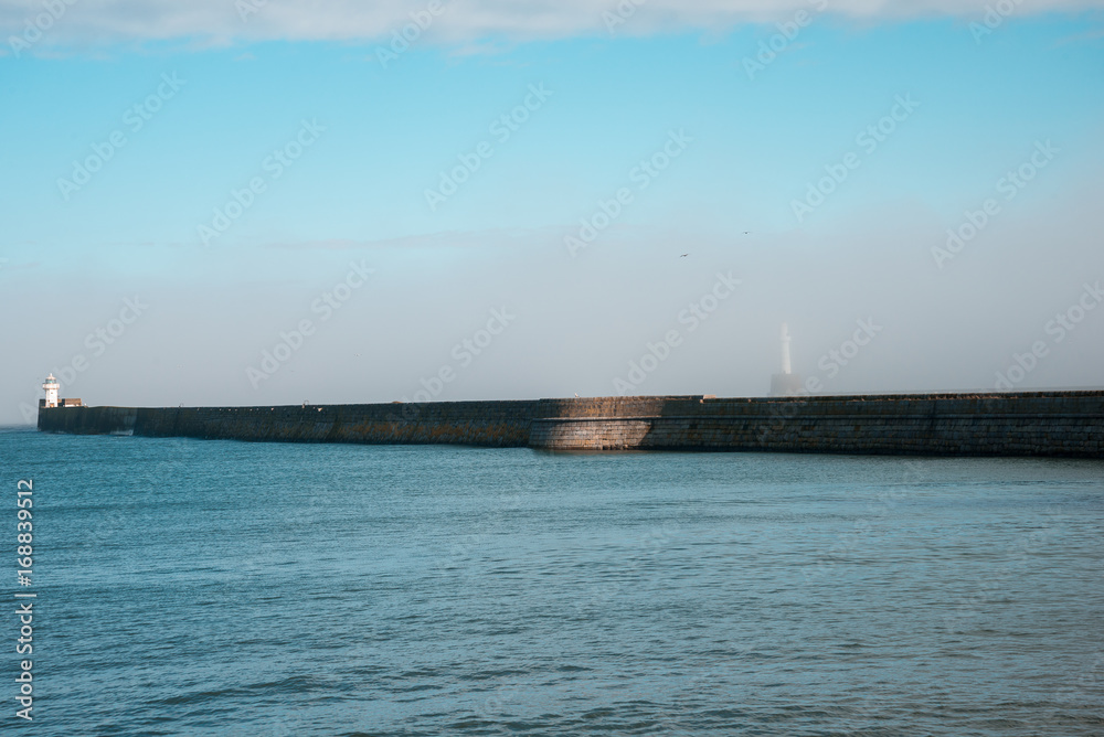 Lighthouse hiding in a haze in Aberdeen Harbour entrance