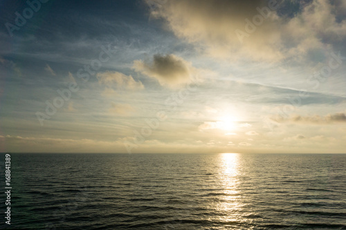 Beautiful beach landscape with sunset sky and soft waves over sand