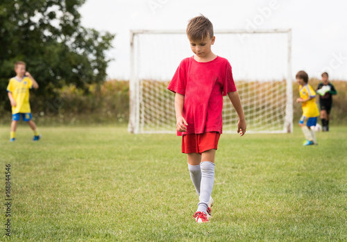 Kids soccer football - children players match on soccer field