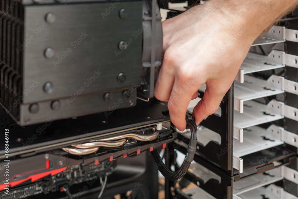 Man hand Connecting The Power Supply To The Graphics Card Man hand Connecting The Power Supply To The Graphics Card