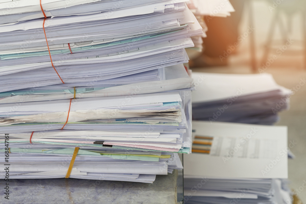 Close up of business documents stack on desk , report papers stack Close up of business documents stack on desk , report papers stack