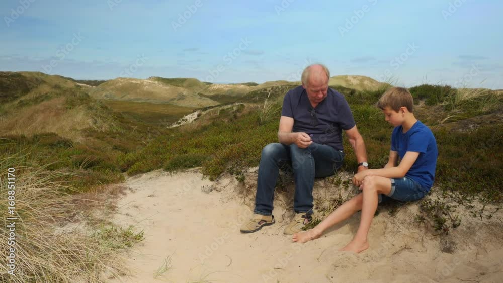 Grandpa on hill telling grandchild about plants Grandpa on hill telling grandchild about plants