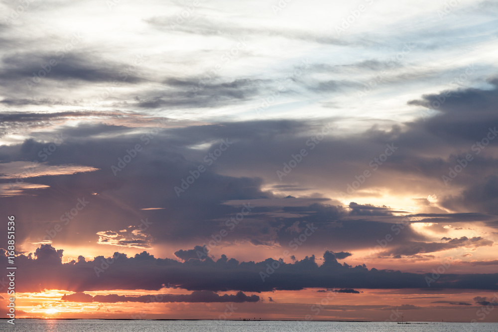 Natural sunset sunrise and light rays over tropical sea in twilight period . Bright dramatic Sky at horizon on the beach .The power of the Sun and nature concept.Toned warm pastel colours photo. Natural sunset sunrise and light rays over tropical sea in twilight period . Bright dramatic Sky at horizon on the beach .The power of the Sun and nature concept.Toned warm pastel colours photo.