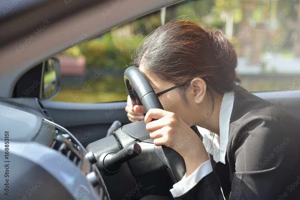 Business woman sleeping while driving a car. Business woman sleeping while driving a car.