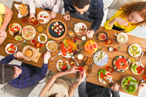 People eat healthy meals at served table dinner party