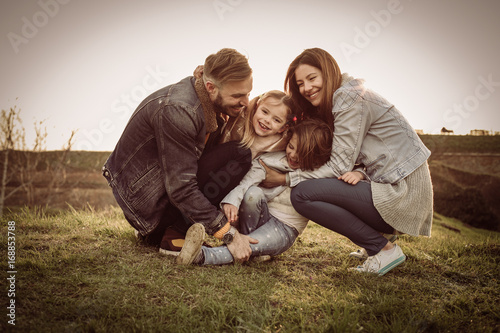 Happy family playing outdoor. Family enjoying together in nature.