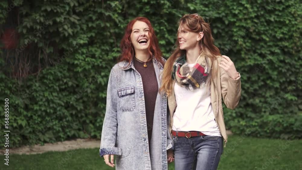 Girlfriends are walking around the city and holding hands. Best friends together. 20s