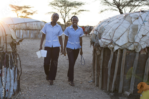 Two nurses working in rural village location. Kenya, Africa.