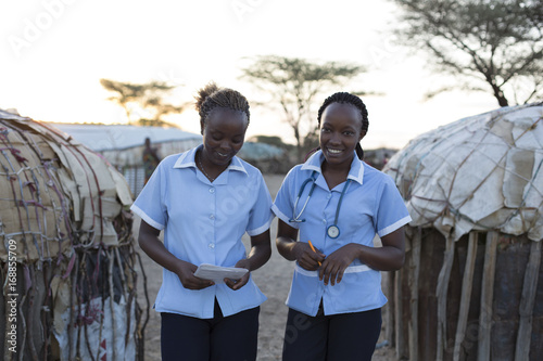 Two Nurses working on location in rural village. Kenya, Africa. photo