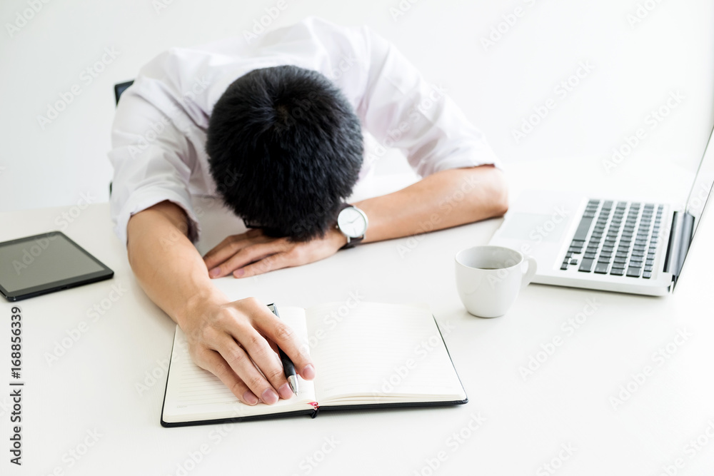 Tired business man is sleeping at his table with laptop. Tired business man is sleeping at his table with laptop.