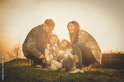 Happy family playing outdoor. Family enjoying together in nature.