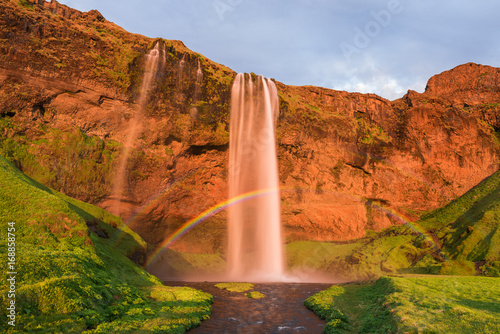 Seljalandsfoss waterfall with a rainbow in Iceland