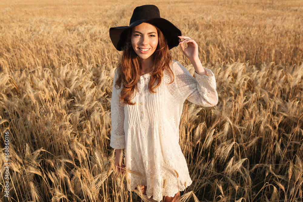 Beautiful young woman standing in the field