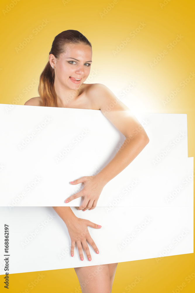 Beautiful young woman with a white empty blank pose in the studio on a yellow background Beautiful young woman with a white empty blank pose in the studio on a yellow background