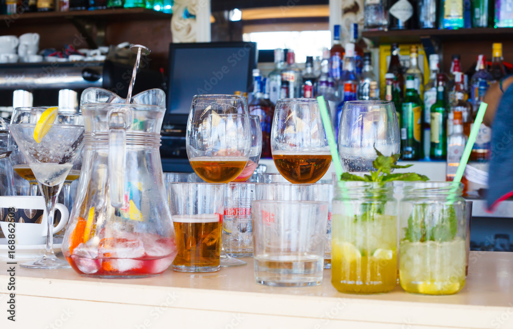Drinks and empty glasses on bar Drinks and empty glasses on bar