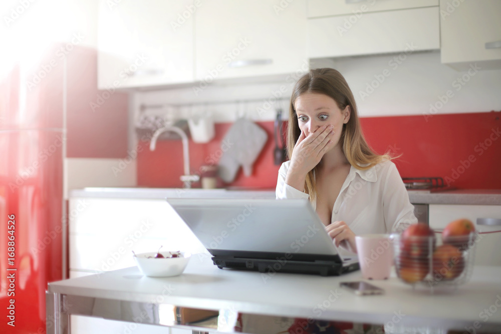 Girl scared by something she just saw in her laptop Girl scared by something she just saw in her laptop