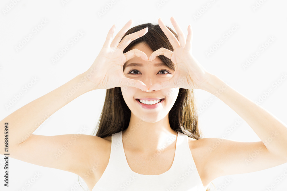 Happy young Woman Holding Heart Shaped Hands Near Eyes. Happy young Woman Holding Heart Shaped Hands Near Eyes.