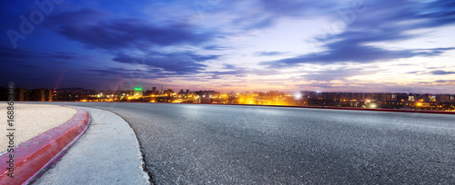 empty road and cityscape of modern city at twilight