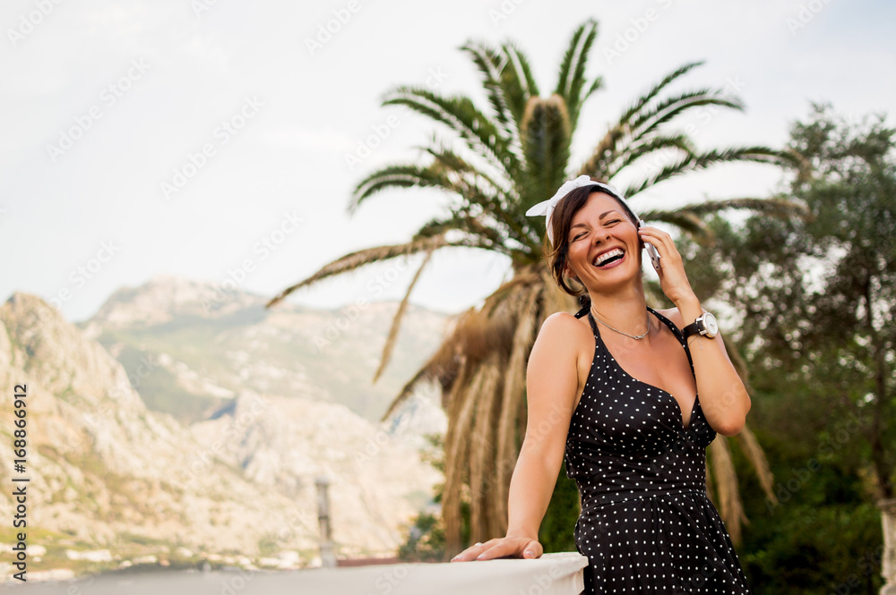 Stylish woman in summer outfit talking on phone. Stylish woman in summer outfit talking on phone.
