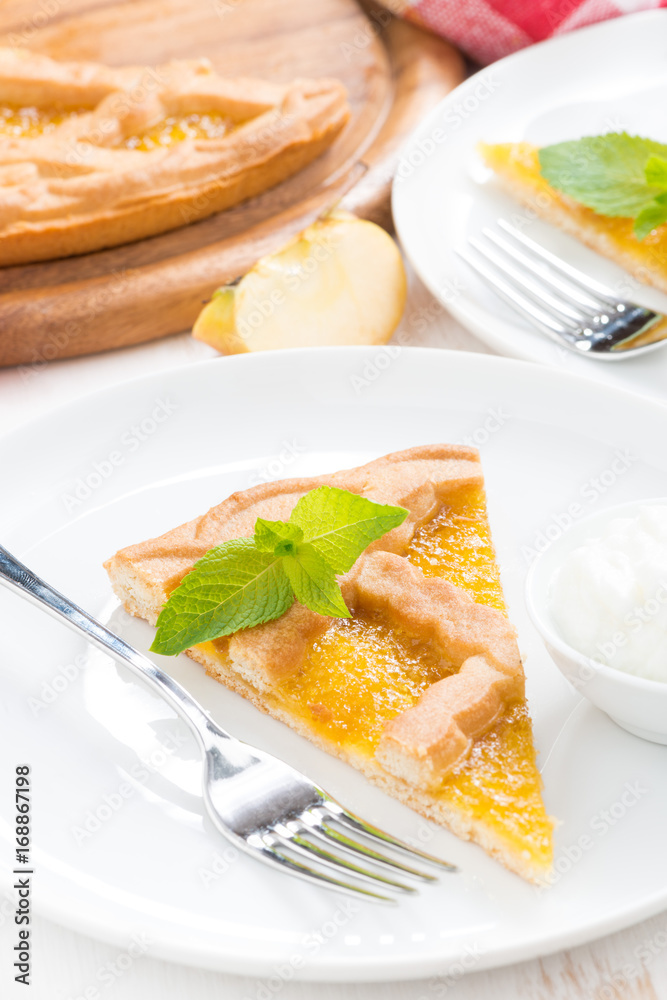 piece of fresh apple pie with whipped cream on a plate, vertical