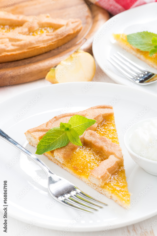 piece of fresh apple pie with whipped cream on a plate, vertical piece of fresh apple pie with whipped cream on a plate, vertical