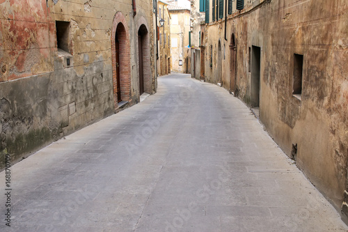 Fototapeta Naklejka Na Ścianę i Meble -  Narrow street in historic center of  Montalcino town, Val d'Orcia, Tuscany, Italy