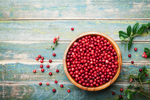 Tablou pe pânză Organic fresh cowberry (lingonberry, partridgeberry, foxberry) in wooden bowl on rustic vintage table top view