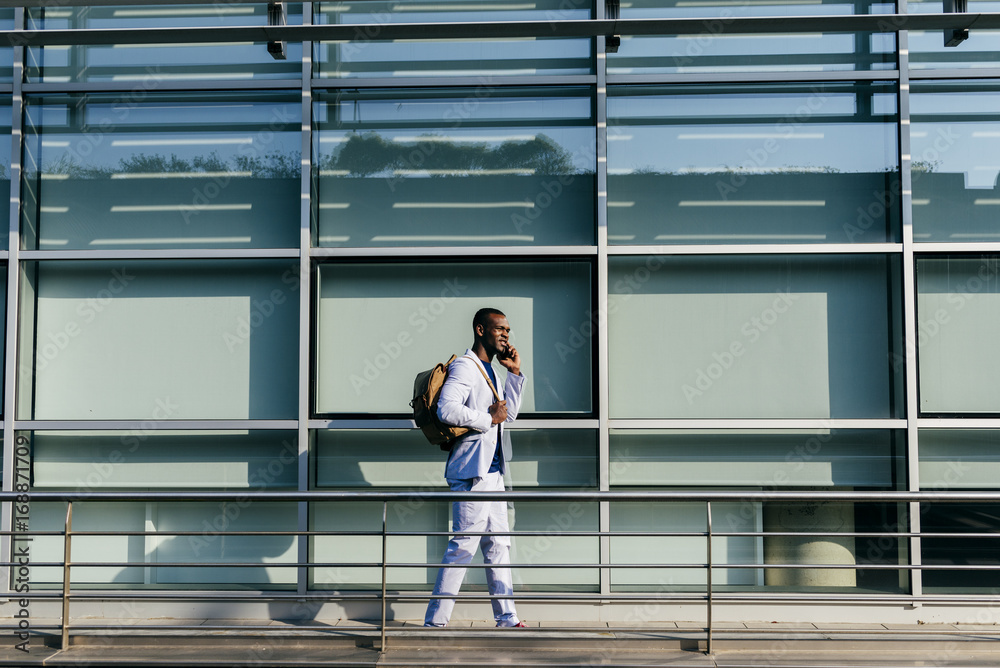 Trendy man walking and talking phone Trendy man walking and talking phone