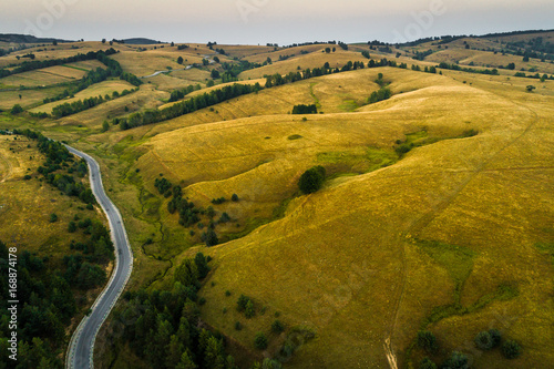 Aerial view of a road on top of the hills at sunset