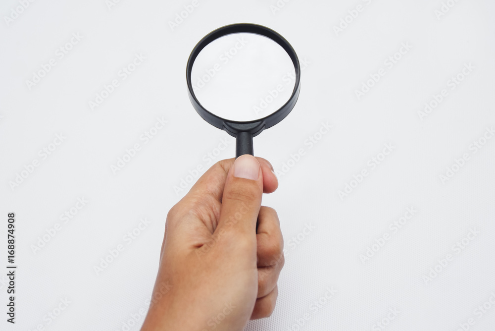 Hand Holding Magnifying Glass Over White Background Hand Holding Magnifying Glass Over White Background