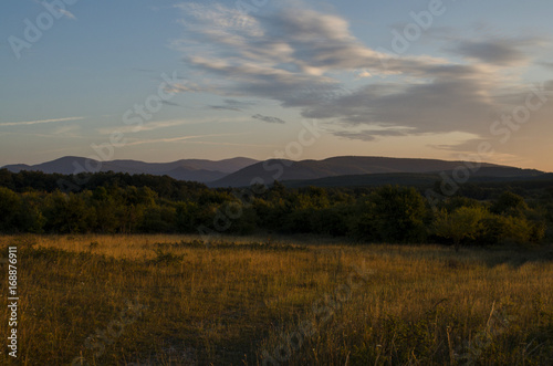 view of mountain silhouette on twilight sky after sunset, summer landscape of hills outdoor