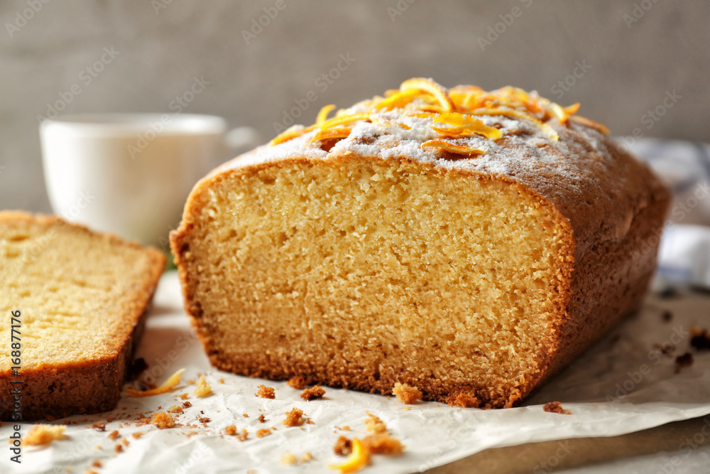 Closeup view of delicious sliced citrus cake on grey table Closeup view of delicious sliced citrus cake on grey table
