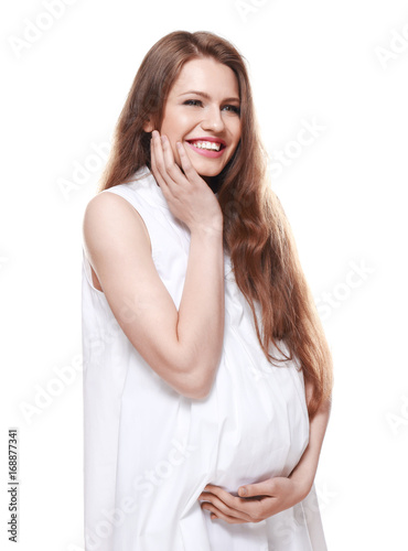 Emotional pregnant woman on white background. Pregnancy hormones concept © Africa Studio