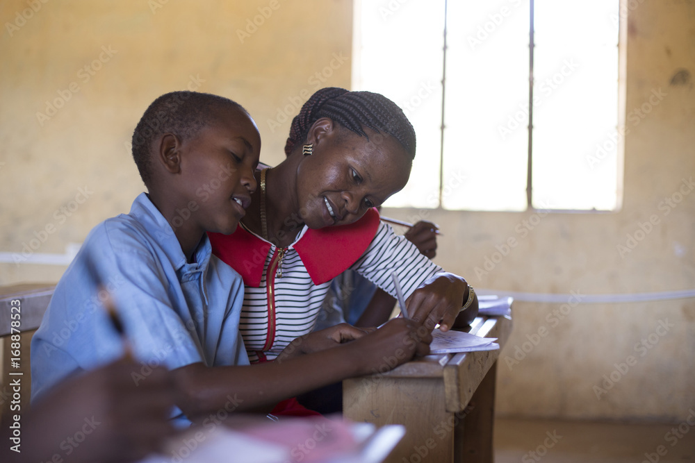 © Hugh Sitton - Teacher teaching in classroom with school children. Kenya, Africa. © Hugh Sitton - Teacher teaching in classroom with school children. Kenya, Africa.