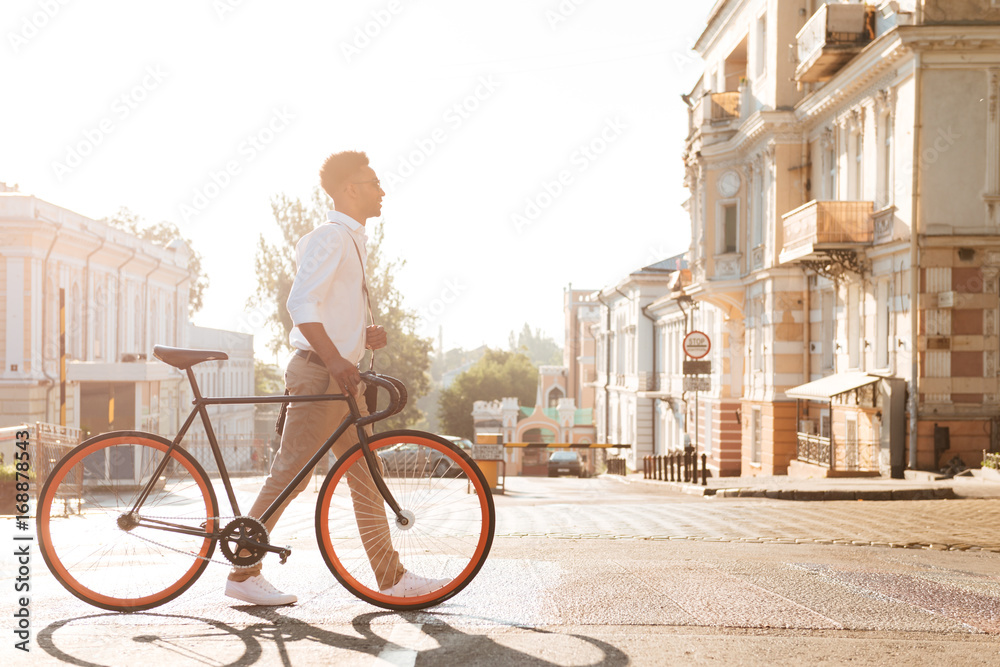 Fototapeta premium African man early morning with bicycle walking outdoors