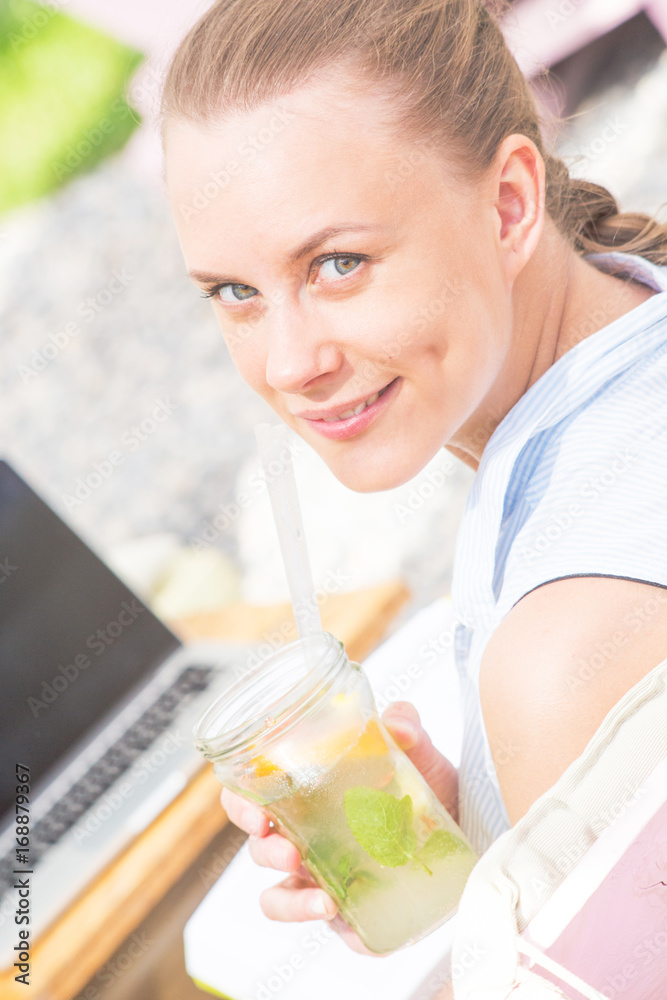 Beautiful and smiling woman surfing on online on her laptop Beautiful and smiling woman surfing on online on her laptop