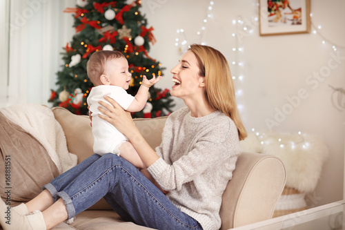 Happy young mother with bab...