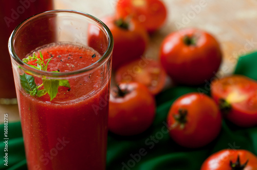 Wallpaper Mural Glass and bottle of tomato juice with vegetables and green napkin on wooden background Torontodigital.ca